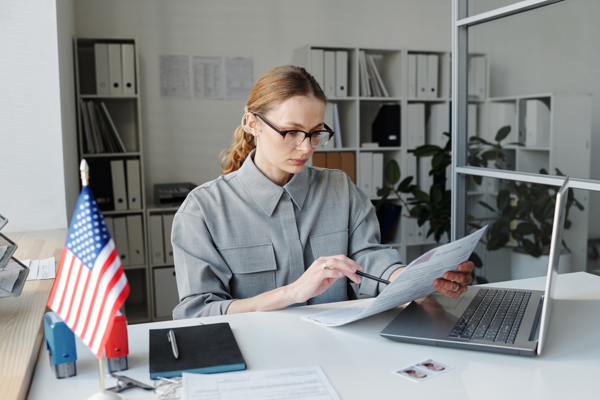 Researcher reviewing documents to compare EB-1A vs EB-2 NIW green card options for researchers