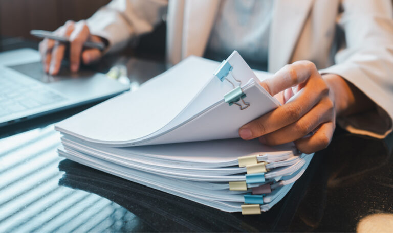 Researcher reviewing EB-1A peer review evidence for an immigration petition.